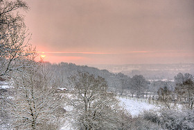 A snowy sunrise across the valley